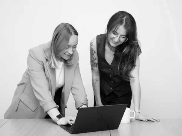 Tamara and Georgia reviewing work on a laptop