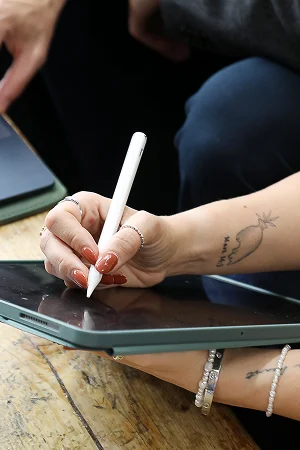 image of team member holding ipad image of team member holding ipad