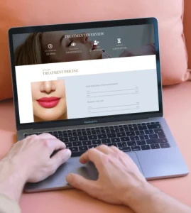 laptop showing homepage of aesthetic clinic website laptop showing homepage of aesthetic clinic website